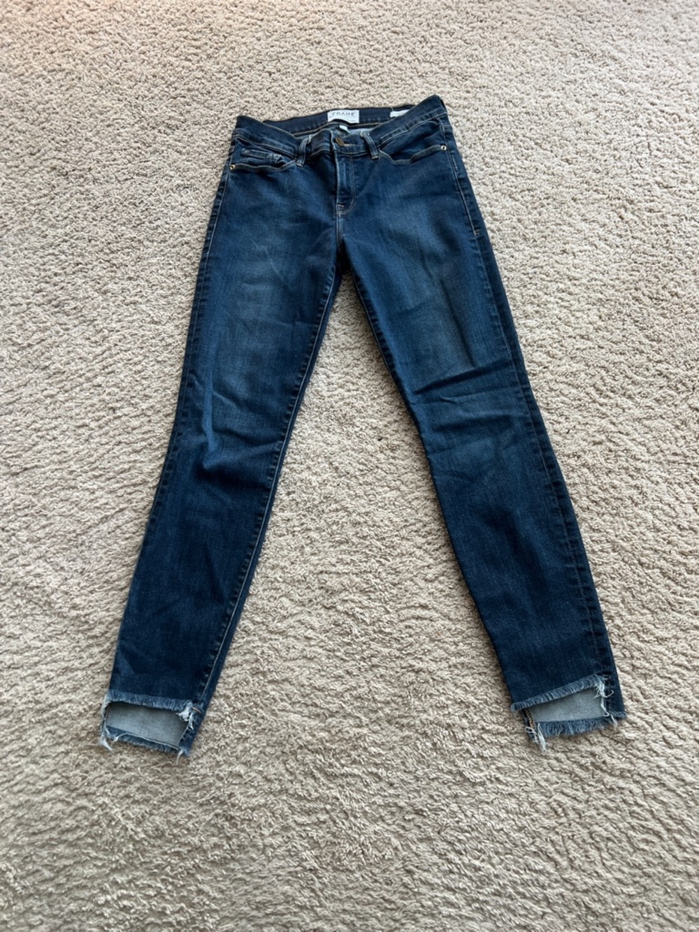 Frame Le High Skinny Jeans medium blue wash with distinctive raw fringed hem